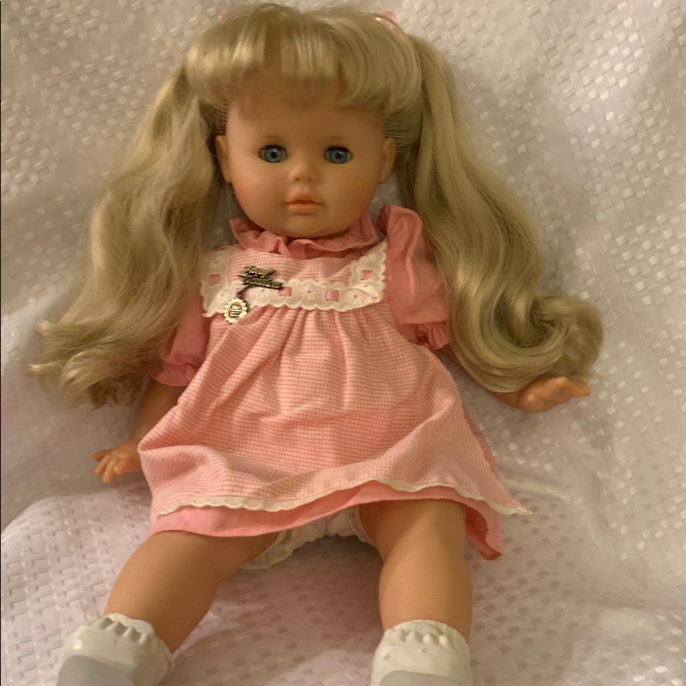 Zapf Creation doll with long blonde pigtails and blue eyes that open and close.